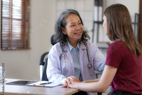 Friendly Doctor Smiling at Patient During Visit. photo