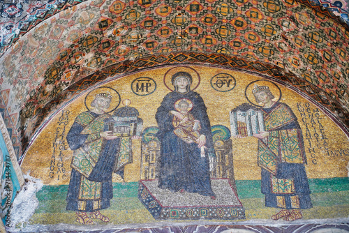 Byzantine mosaic of Virgin Mary  holding the infant Jesus.Constantine offers the city of Constantinople and Justinian the Hagia Sophia church at Istanbul,Turkey photo