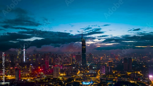An establish aerial hyperlapse shot of Kuala Lumpur city overseeing the main four towers skyscrappers during low cloud morning photo