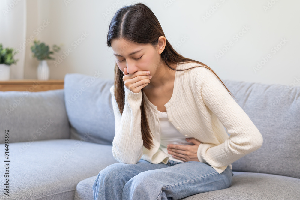 Unhappy pregnant asian young woman, pain girl suffering from nausea, having vomit feeling sick covering mouth, touching belly having problem throwing up from food poisoning, lady with morning sickness