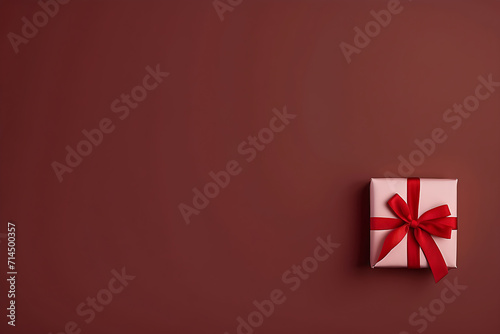 Gift box with red ribbon on red background. Top view with copy space © UN