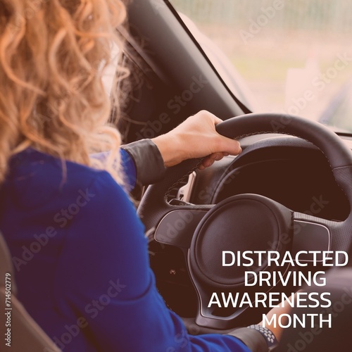 Composition of distracted driving awareness month text over caucasian woman driving car photo