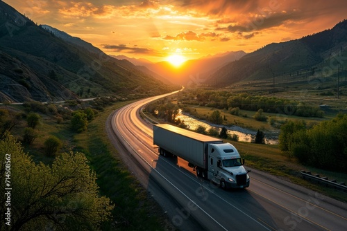 Semi truck driving on highway during sunset in mountainous area © ParinApril