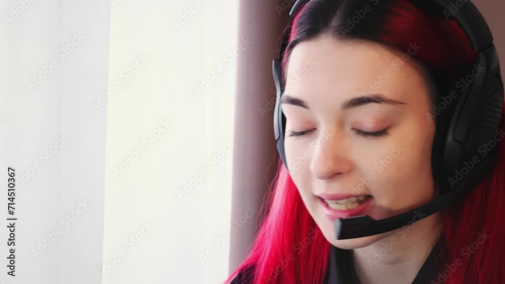 Closeup view of woman in headset holding online lesson with a student talking through microphone. Friendly young adult female teacher is explaining rules during quarantine by electronic education Closeup view of woman in headset holding online lesson with a student talking through microphone. Friendly young adult female teacher is explaining rules during quarantine by electronic education