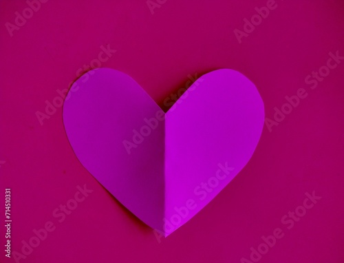 Purple hearts isolated on pink background, Valentine's Day background with copy space.