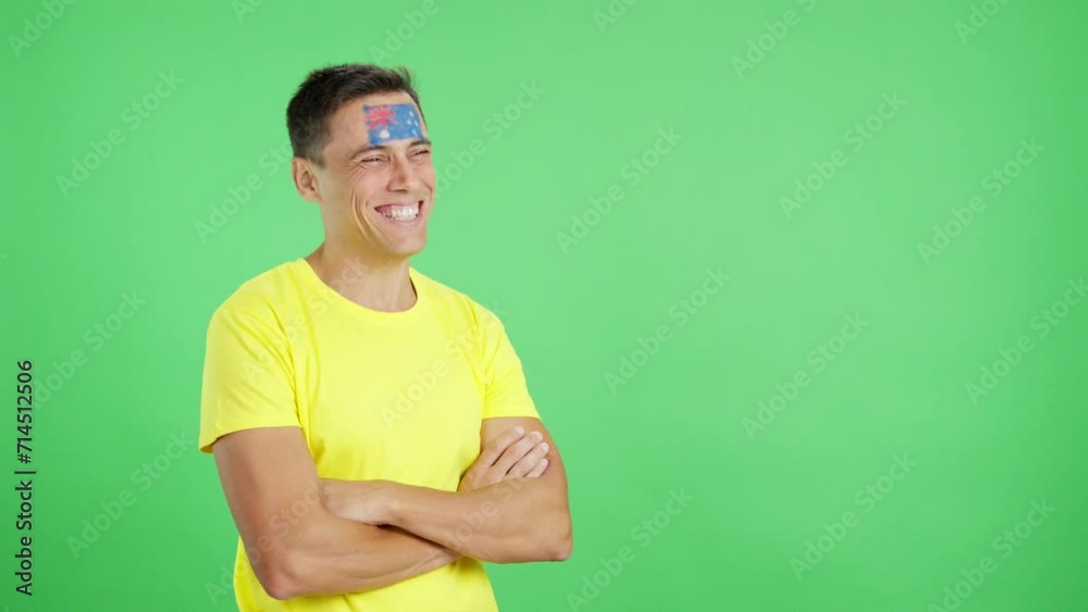 Happy man with australian flag painted on face looking away Happy man with australian flag painted on face looking away