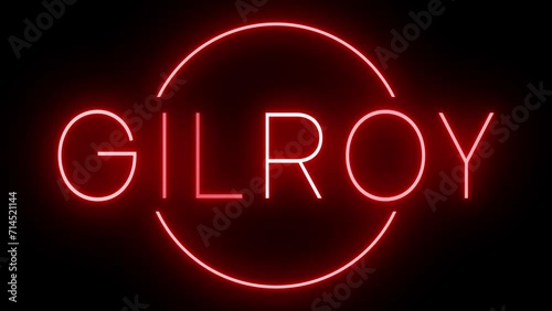 Flickering red retro style neon sign glowing against a black background for GILROY photo