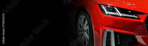 Red modern sport car headlights on black background, copy space © I Viewfinder