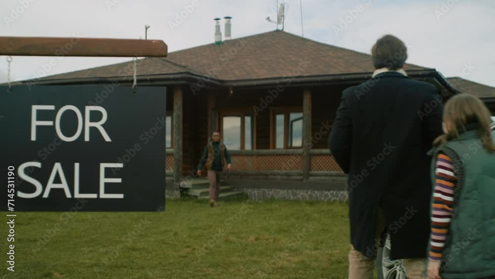 For sale sign on lawn. African American real estate agent meets couple ...