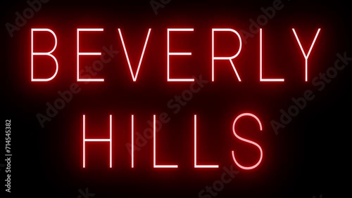Flickering red retro style neon sign glowing against a black background for BEVERLY HILLS