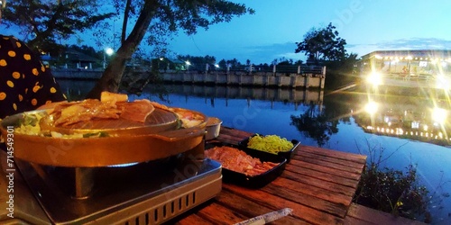 Grilled pork with a chill atmosphere along the Mae Klong River, Samut Songkhram Province, Thailand photo