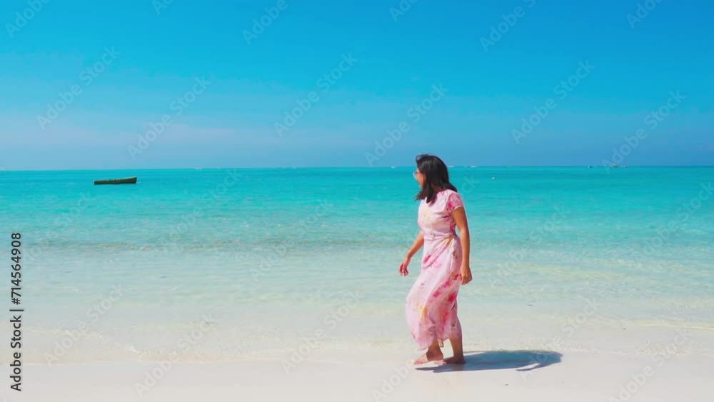 Pretty Indian young woman walking at beach of Lakshadweep island, India. Social media influencer at beach. Tourist at beautiful white sand beach. Girl walking along shore on summer vacation Pretty Indian young woman walking at beach of Lakshadweep island, India. Social media influencer at beach. Tourist at beautiful white sand beach. Girl walking along shore on summer vacation