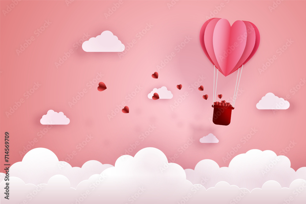 Paper cut art and digital craft style of love and valentine concept. Origami of hot air balloon flying over sky and cloud with floating hearts.