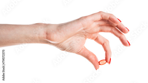 Hand holding a red capsule isolated on white background. Red pill isolated.