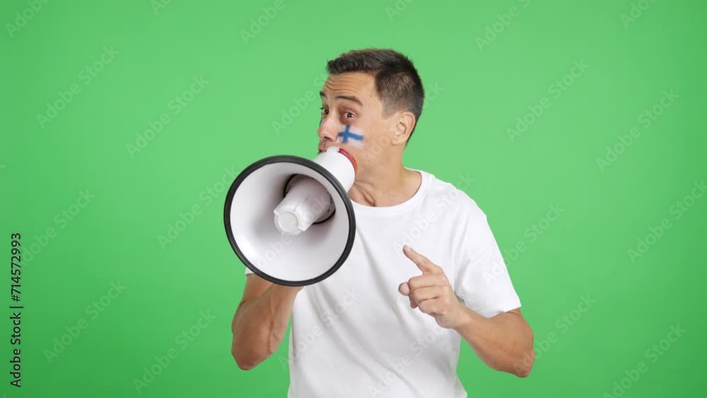 Excited man with finnish flag on face using a megaphone Excited man with finnish flag on face using a megaphone