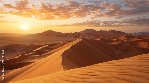  the sun sets over a desert landscape with sand dunes in the foreground and mountains in the distance in the distance, with a few clouds in the sky above the horizon.