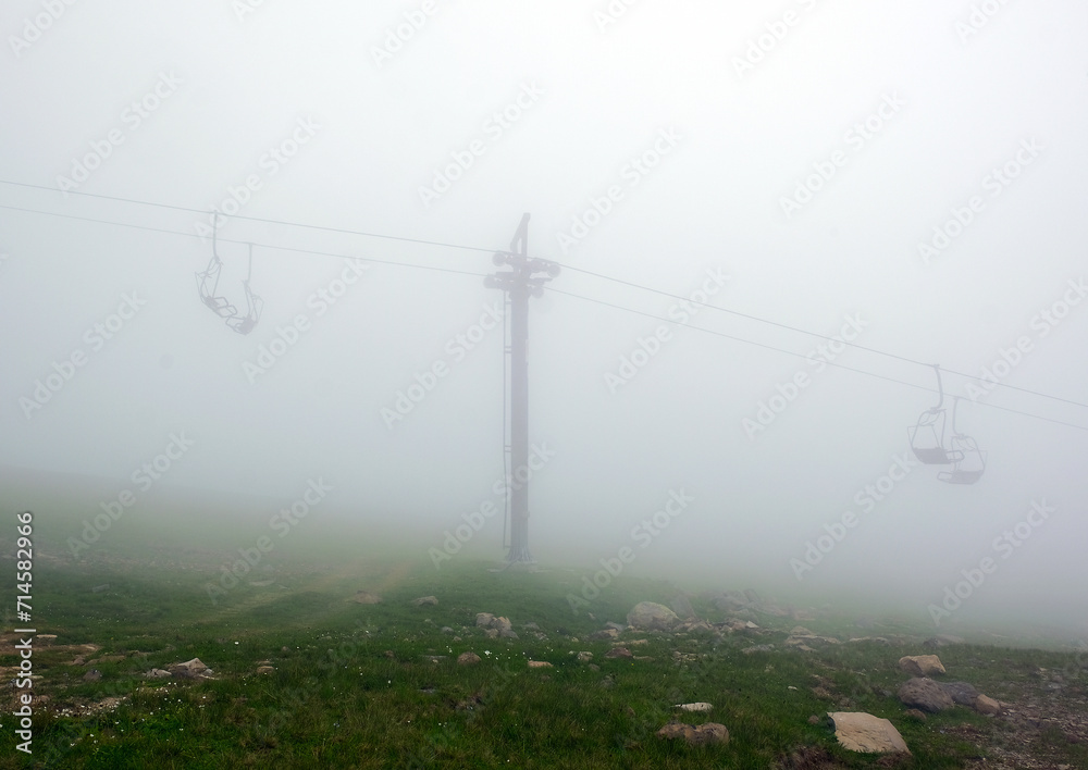 Empty Chairlifts with No People in Thick Fog on Abandoned Ski Elevator