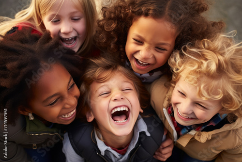 A group of multiracial children sharing a hearty laugh together, demonstrating the bond of friendship and camaraderie