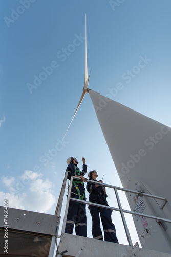 Engineers working on site in wind turbine farm, Wind turbines generate clean energy source, Eco technology for electric