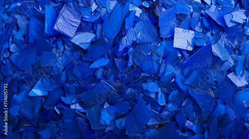 Textured background of cobalt blue crushed glass pieces, ideal for concepts related to recycling, environment, or abstract art