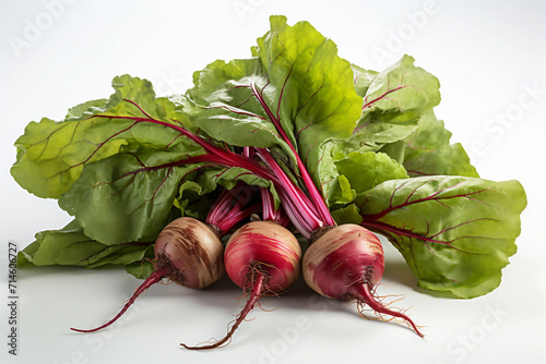 A pile of shiny beetroots with leaves tucked behind.