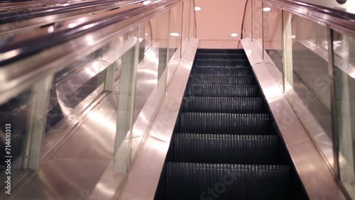 Movement of lifting on modern shiny escalator in building photo