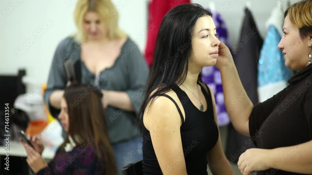 Two girls models and makeup artists in the studio. Two girls models and makeup artists in the studio.