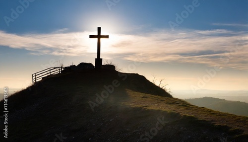 christianity depicted by silhouette of cross on calvary hill against sky backdrop