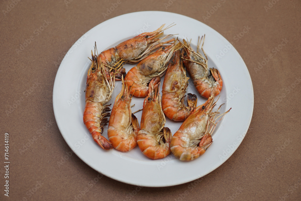 Grilled prawns, river shrimps on white plate. Concept, seafood. Delicious, favorite menu for party or outdoor barbeque or picnic. Healthy food. Ready to eat. Thai eating style. Grilled prawns, river shrimps on white plate. Concept, seafood. Delicious, favorite menu for party or outdoor barbeque or picnic. Healthy food. Ready to eat. Thai eating style.