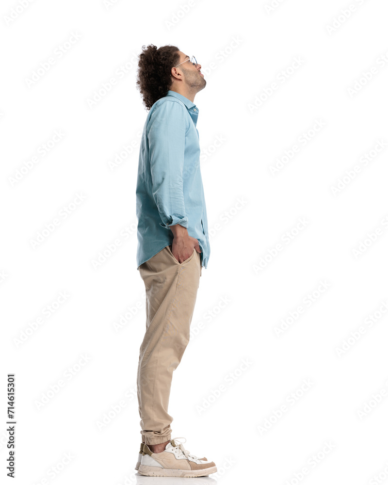 young man waiting in line and looking up young man waiting in line and looking up