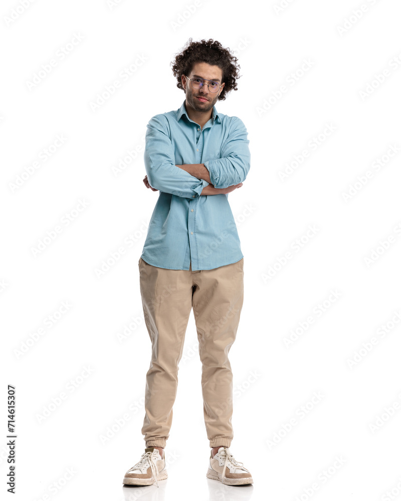confident and handsome casual man standing with arms crossed confident and handsome casual man standing with arms crossed