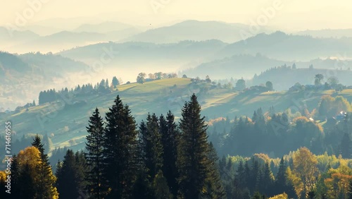 Evening sunset in the Carpathians over the Vorokhta and Yasinya Ukraine valley brightly painted paints over the dark mountains and ridges of Gorgan and the glowing lights of houses