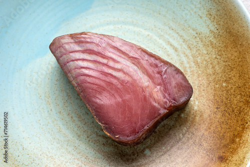Cold smoked tuna on a plate. Close up