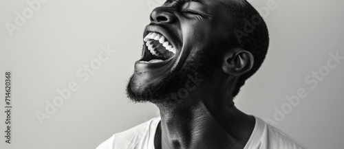 A monochrome portrayal of raw emotion  capturing a man s hearty laughter and the infectious joy it conveys