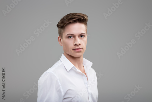Poised demeanor, white shirt, youthfully sophisticated air photo
