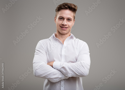 White shirted man, confident, arms crossed, approachable © Giulio_Fornasar