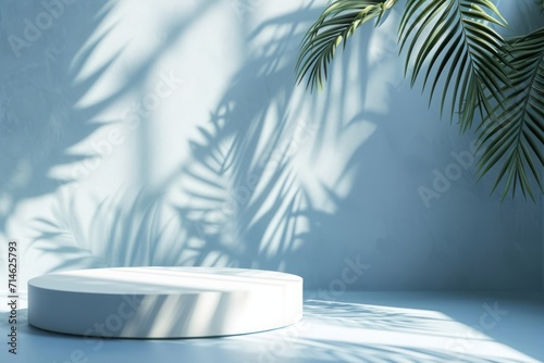 Abstract blue background with white podiums and tropical palm leaves with shadows