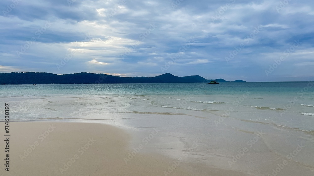 Tranquil beach scene with clear waters, white sands, and distant hills under an overcast sky, encapsulating a mood of peaceful vacation Earth Day concept Tranquil beach scene with clear waters, white sands, and distant hills under an overcast sky, encapsulating a mood of peaceful vacation Earth Day concept