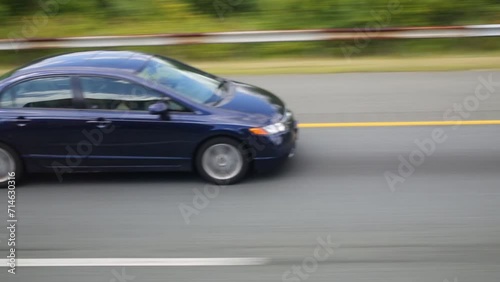 Fast motion in car on road with other cars at summer day