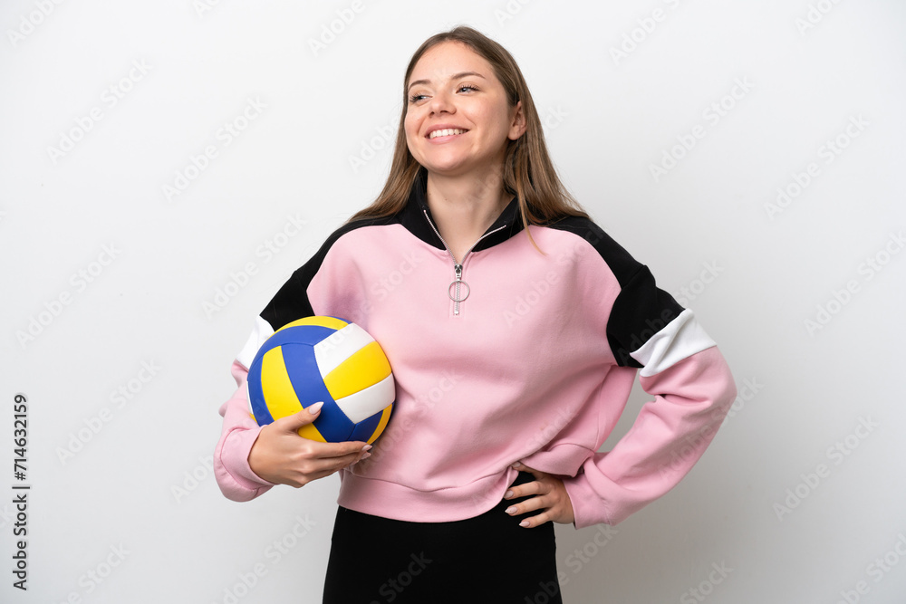 Young Lithuanian woman playing volleyball isolated on white background posing with arms at hip and smiling Young Lithuanian woman playing volleyball isolated on white background posing with arms at hip and smiling