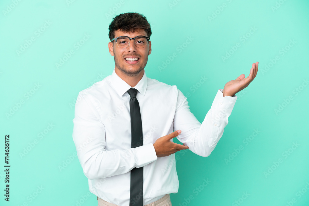 Business caucasian man isolated on blue background extending hands to the side for inviting to come Business caucasian man isolated on blue background extending hands to the side for inviting to come