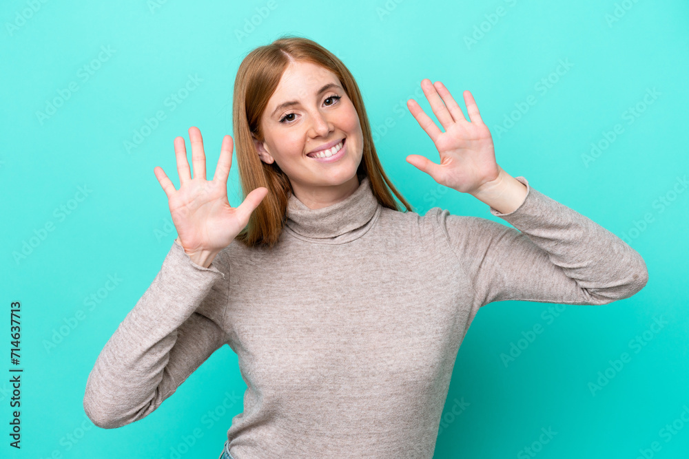 Young redhead woman isolated on blue background counting ten with fingers Young redhead woman isolated on blue background counting ten with fingers