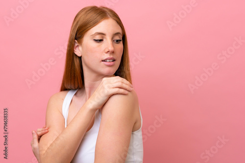Young redhead woman isolated on pink background