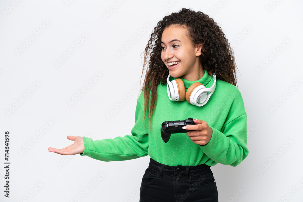 Young Arab woman playing with a video game controller isolated on white background with surprise expression while looking side