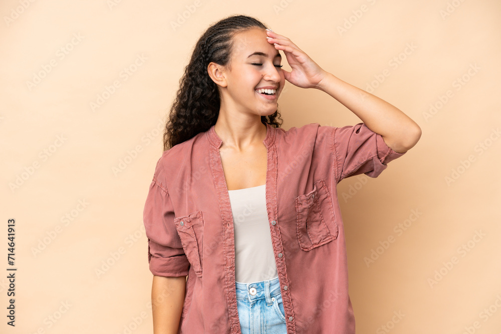 Young woman isolated on beige background smiling a lot Young woman isolated on beige background smiling a lot