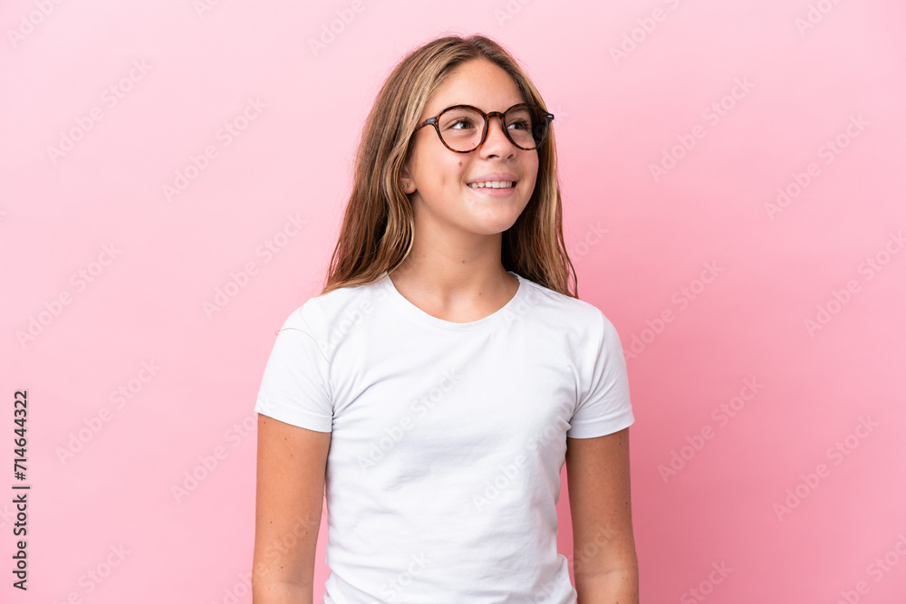 Little caucasian girl isolated on pink background With glasses with happy expression Little caucasian girl isolated on pink background With glasses with happy expression