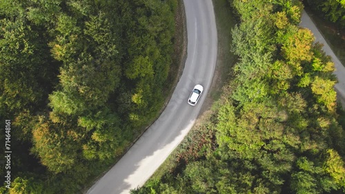 Aerial Shot of A White Car Mazda3 Driving on Road in Pine Tree Forest. Scenic Landscape. Express Delivery Shipping Service. 
