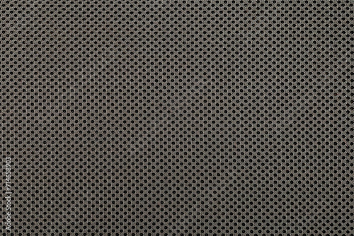 Gray background. Textile texture with small dots. Braided, knitting black threads. 