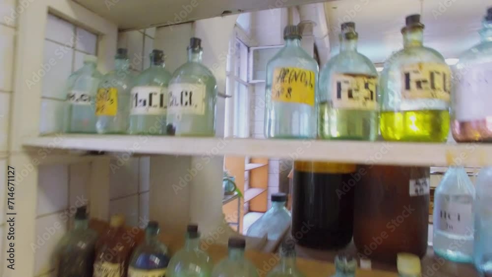 Shelves with many different reagents in bottles at laboratory