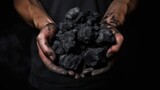 Someone who is carrying coal in his hand